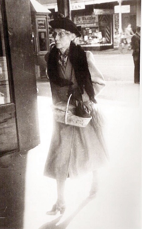 Jessie Bertha Bradley (nee Oliver) on footpath earnestly going about her business.