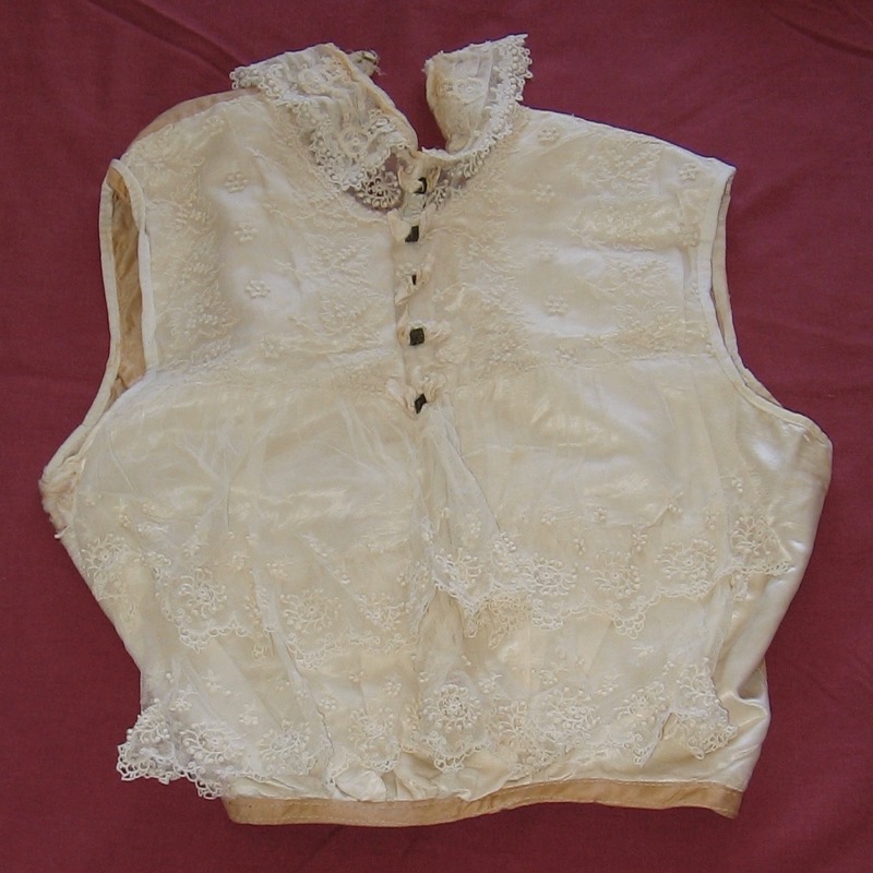 Chemisette/blouse, thought to be Jessie Bertha Oliver's wedding blouse with lace-over. Worn to fill in the front and neckline of a woman's garment.