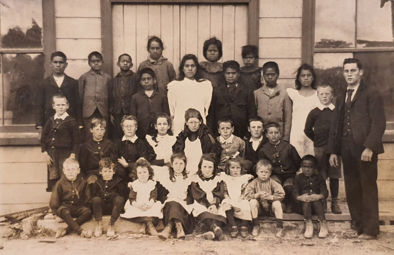 Two eldest Shute girls at Taihape District School circa 1898. Seated behind front row, 3rd from left is Ness Shute. Front row, 3rd from left is Gwen Shute. The teacher is Mr Jack O'Reilly