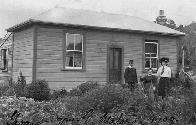 Orpha Shute in 1909 by her house in Mataroa where they lived for a short time before returning to Taihape. Standing thought to be Tom and Lena Shute