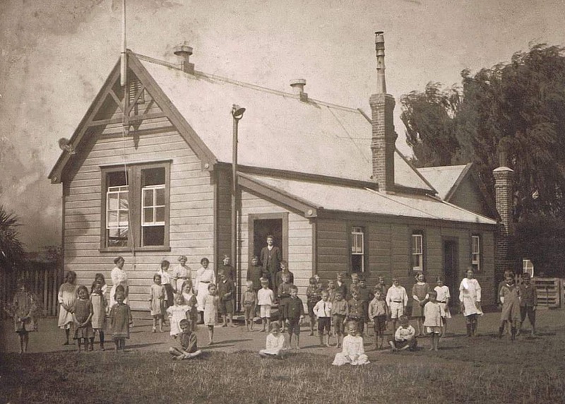 Pukahu School (South of Hastings) with Robert H Florance, headmaster, standing in doorway. Headmaster's residence at rear. Circa 1910