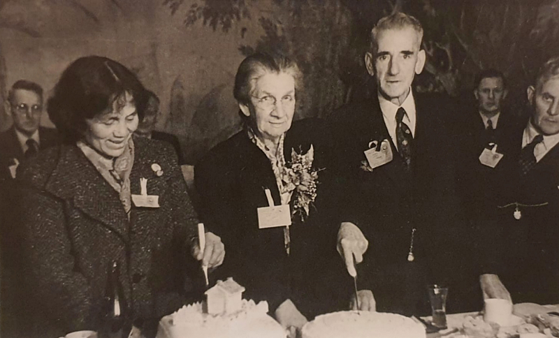 Ness Oliver (nee Shute), in centre of photo, cutting a cake. Taihape school 50th reunion in 1946.